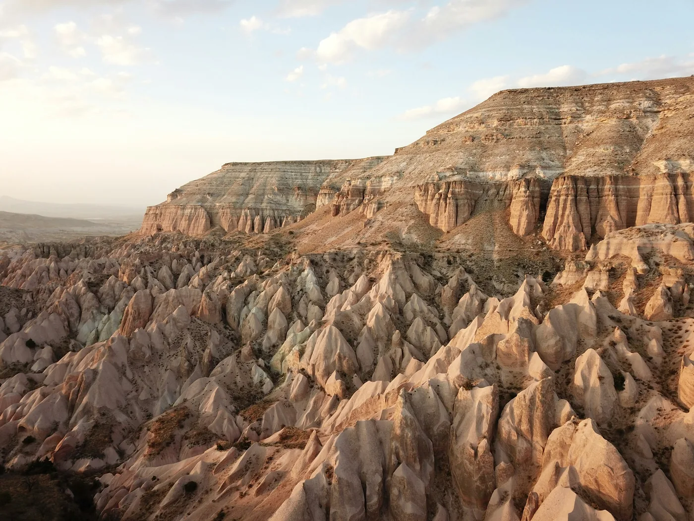 Quad bikes riding into the sunset over Cappadocia's tuff-rock valleys